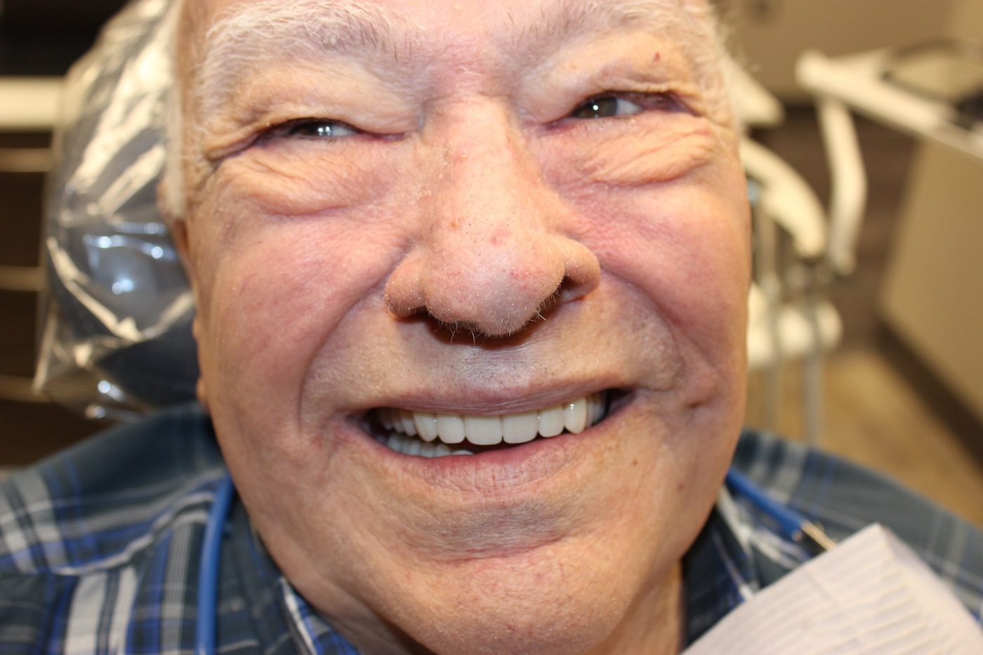 Bob, a 92-year-old World War II veteran, smiling with his new dentures